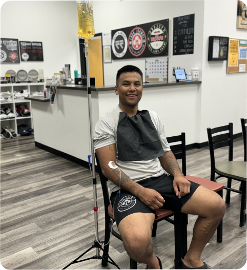 A man is sitting in a chair with an iv in his arm