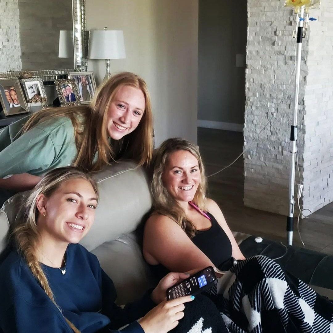 Group of friends relaxing at home during IV therapy session