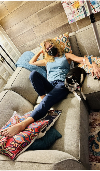 Three people relaxing on a patio, each with an IV bag. They are holding drinks and smiling.