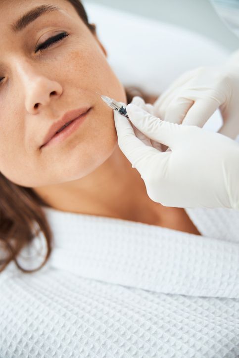 Young woman getting rid of nasolabial folds