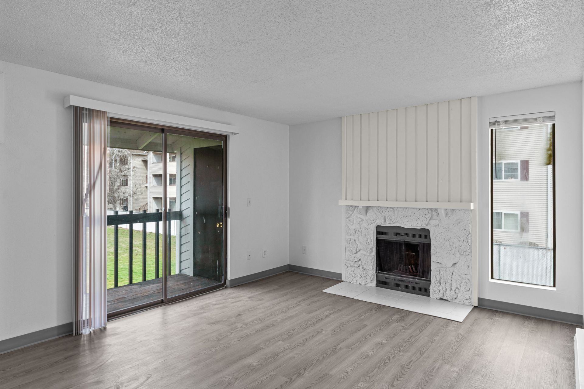 Houk 33 living room with fireplace and patio