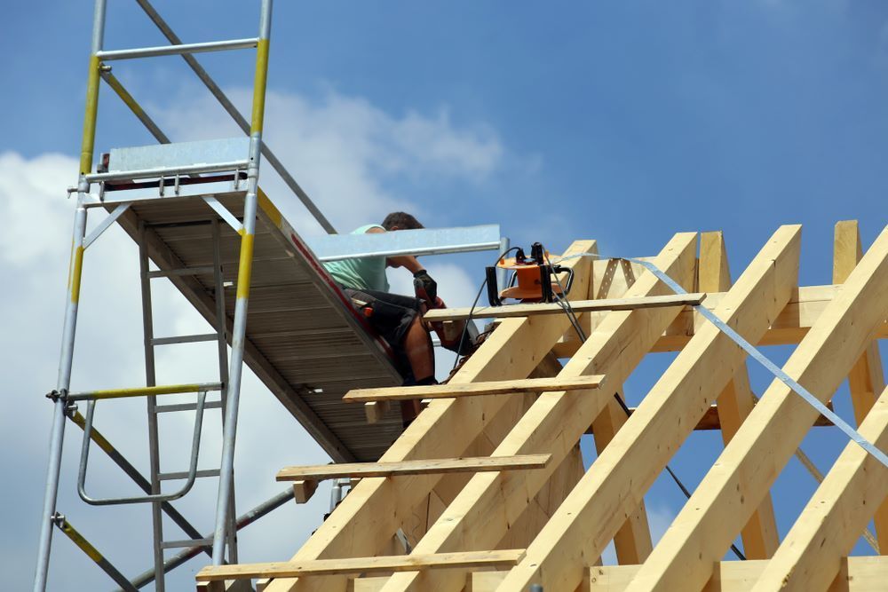 A Man Is Sitting on A Scaffolding — Trussframe in Narrabri, NSW