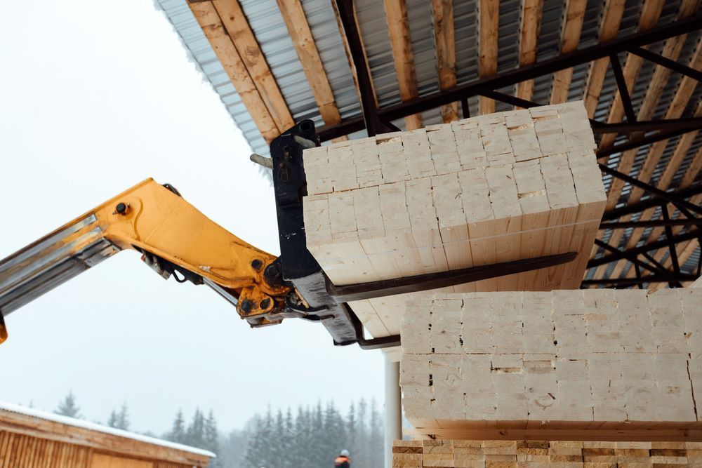 A Crane Is Lifting a Stack of Wooden Blocks — Trussframe in Tenterfield, NSW