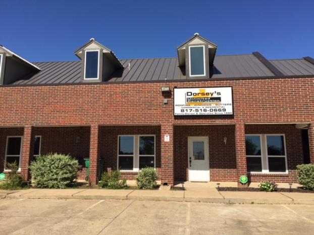 Brick building with Dorsey's Restaurant sign and dormer windows under a clear blue sky.