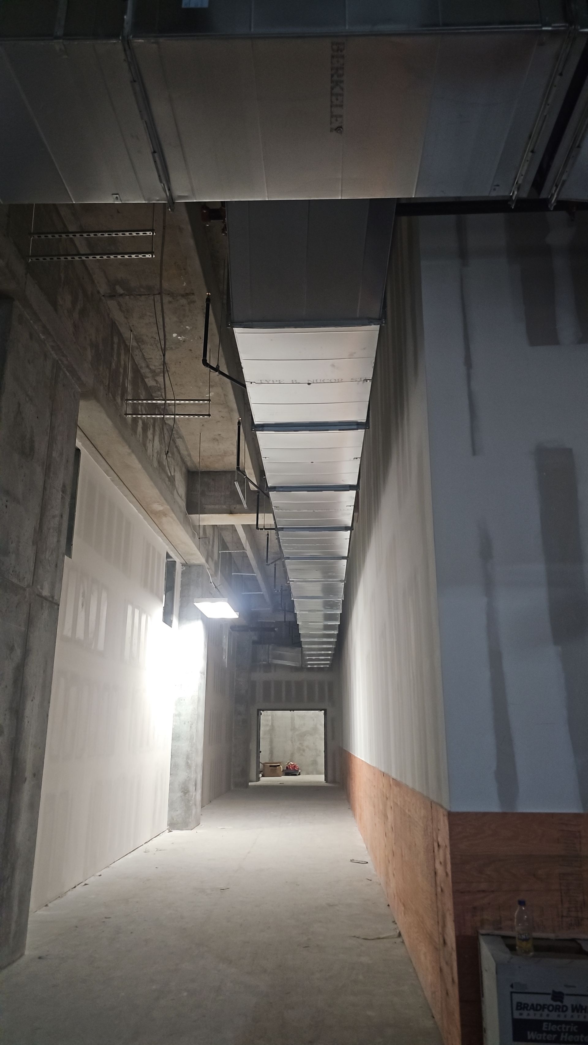A long hallway in a building under construction.