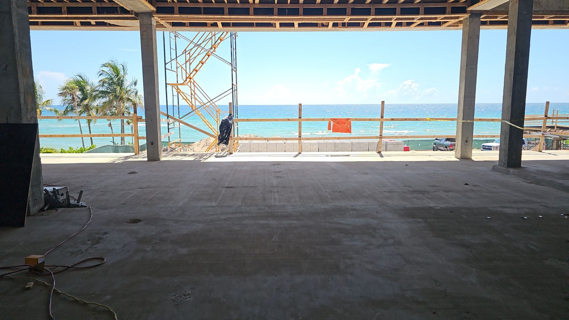 A building under construction with a view of the ocean