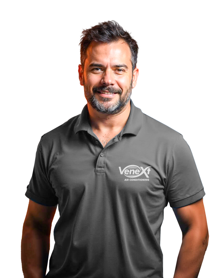 A man with a beard wearing a grey polo shirt
