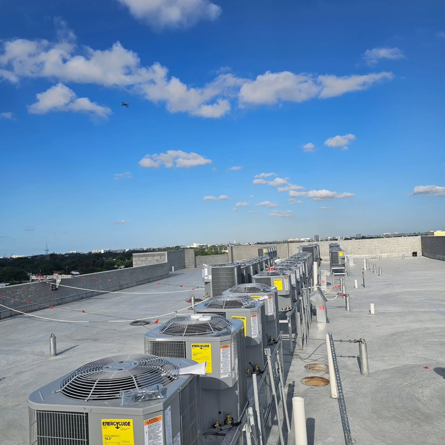 A row of air conditioners on the roof of a building