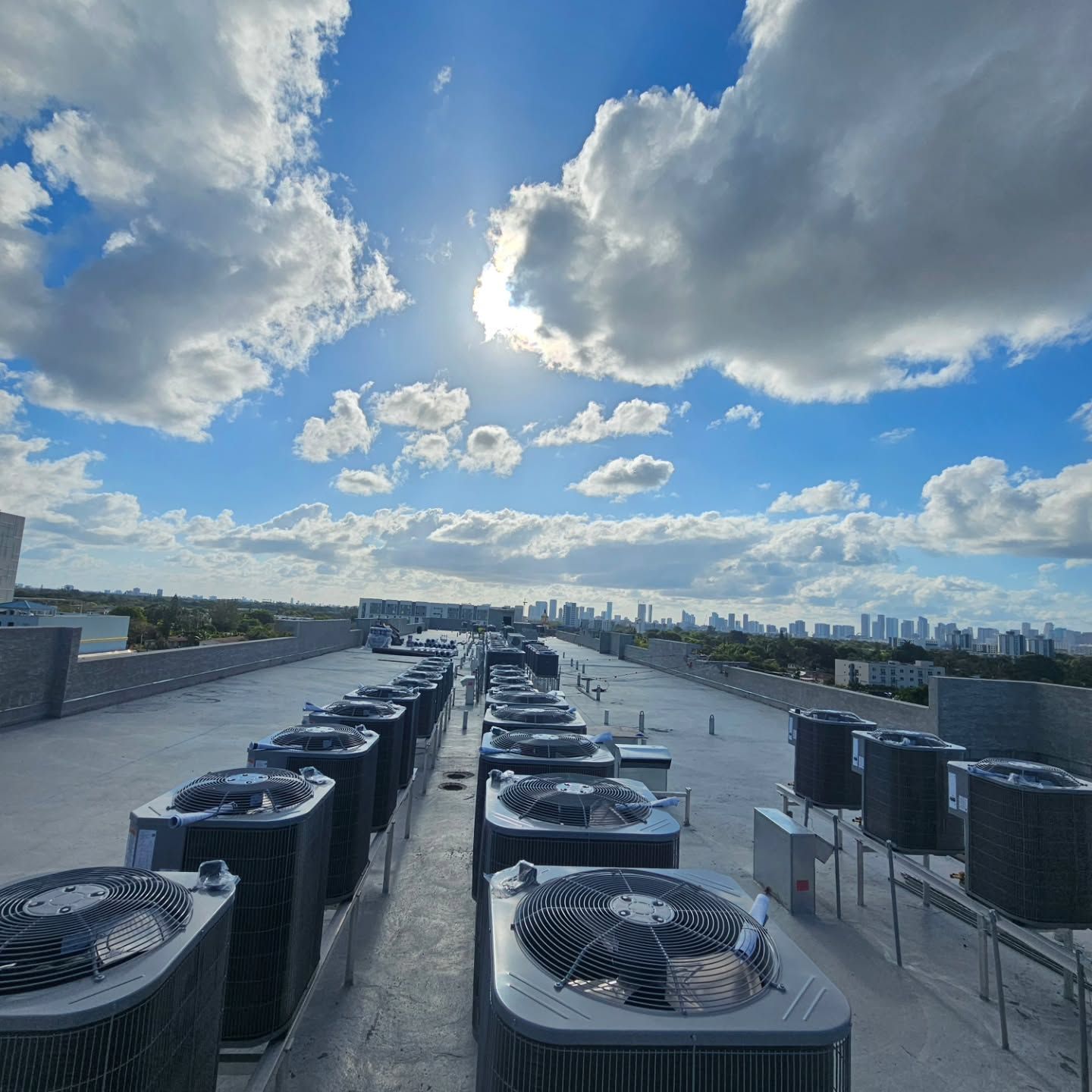 A row of air conditioners on the roof of a building