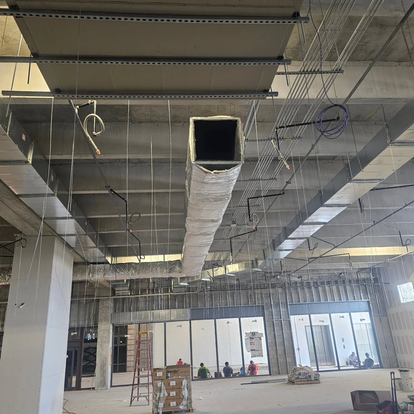 A large room with a lot of ducts hanging from the ceiling