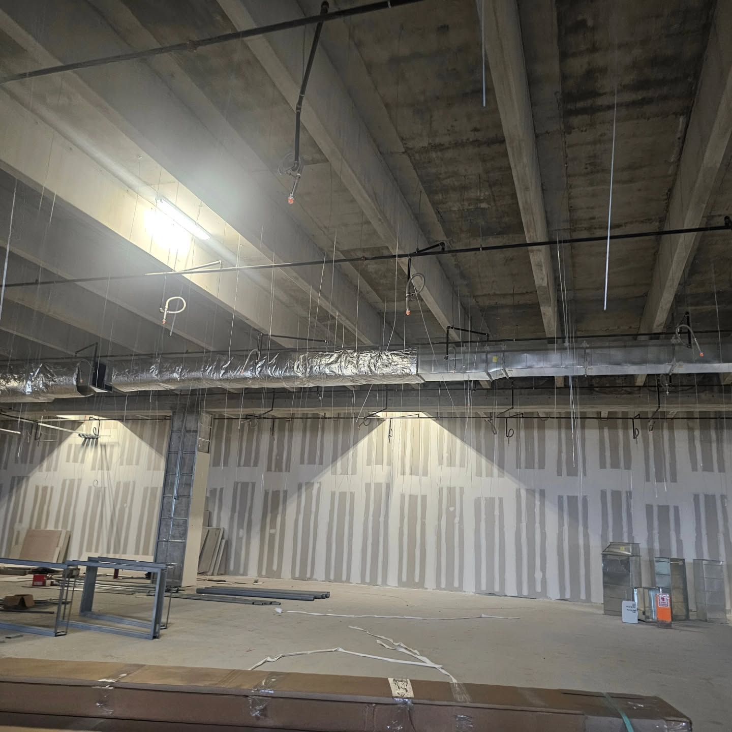 A large empty room with a ceiling that is being remodeled.