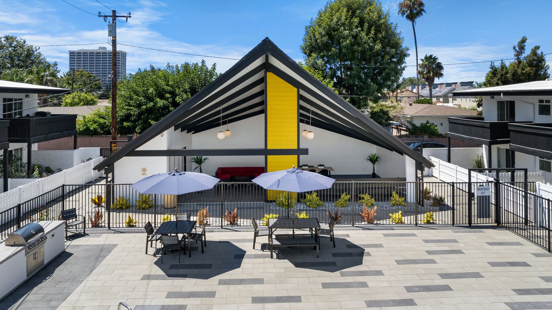 Lanai and picnic tables with pool umbrellas