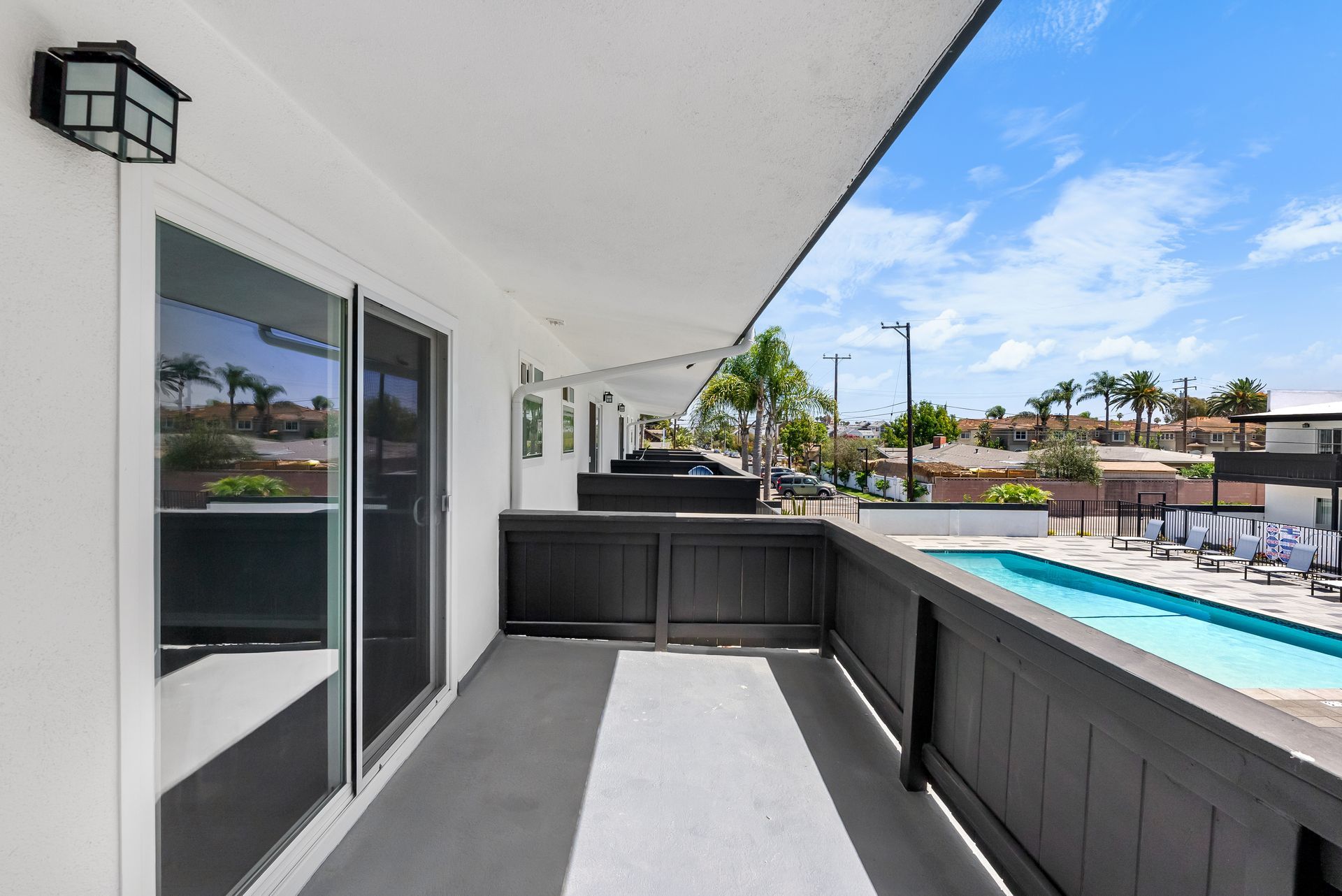 fenced balcony with pool in background