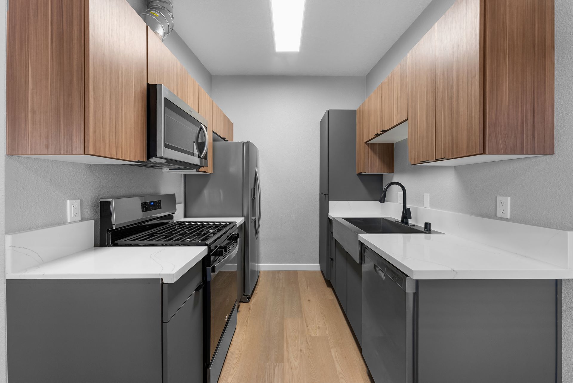 Kitchen with stove, refrigerator, and sink