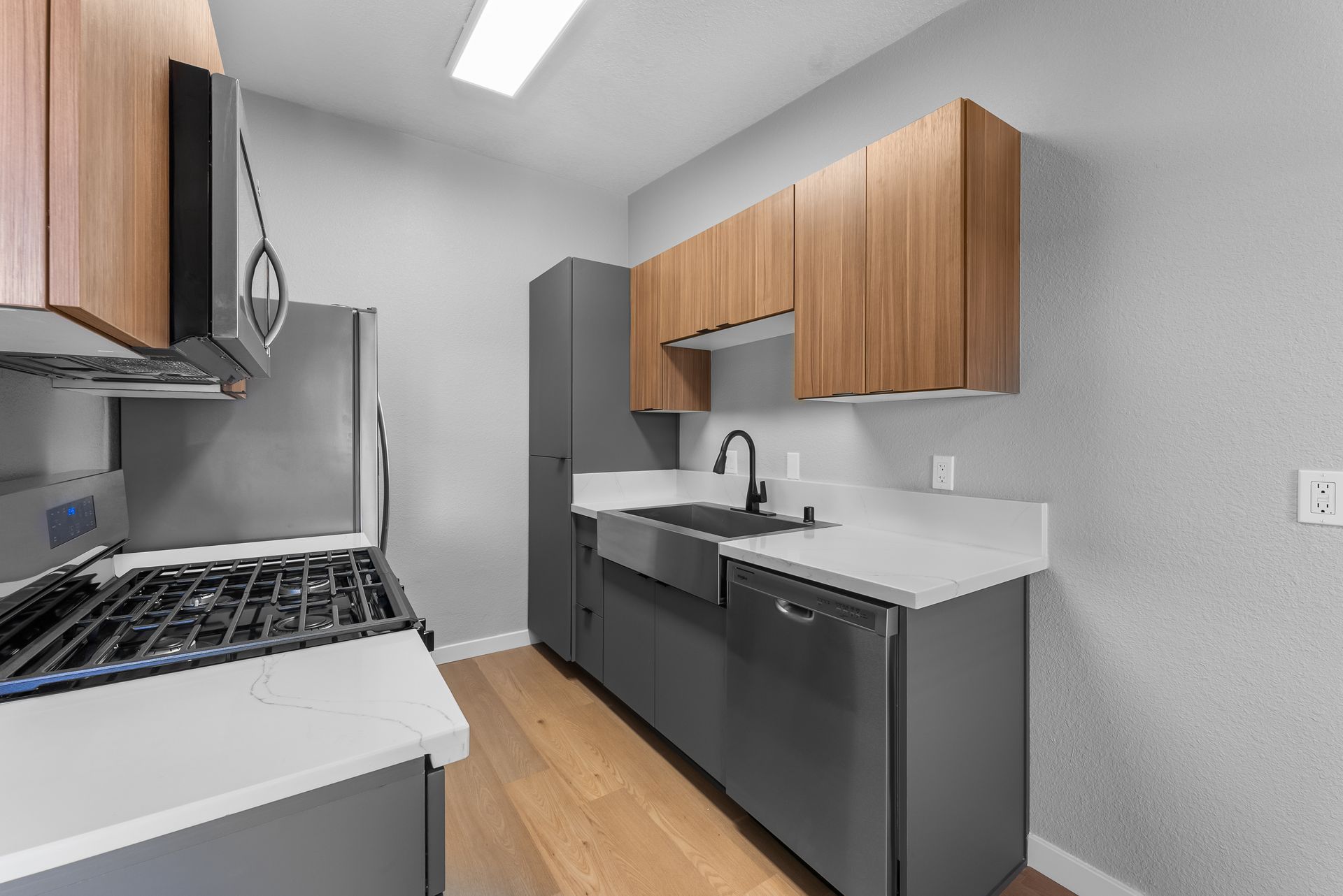 Kitchen with stove, refrigerator, and sink