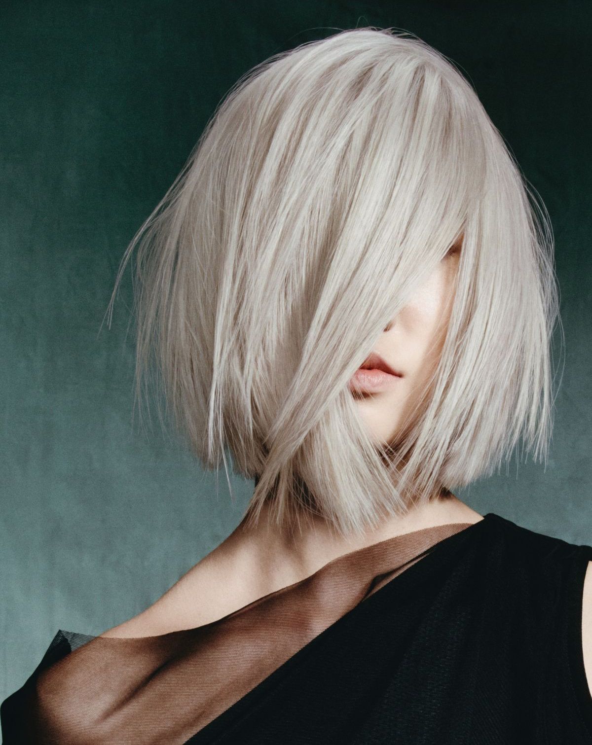 A woman is getting her hair cut by a hairdresser