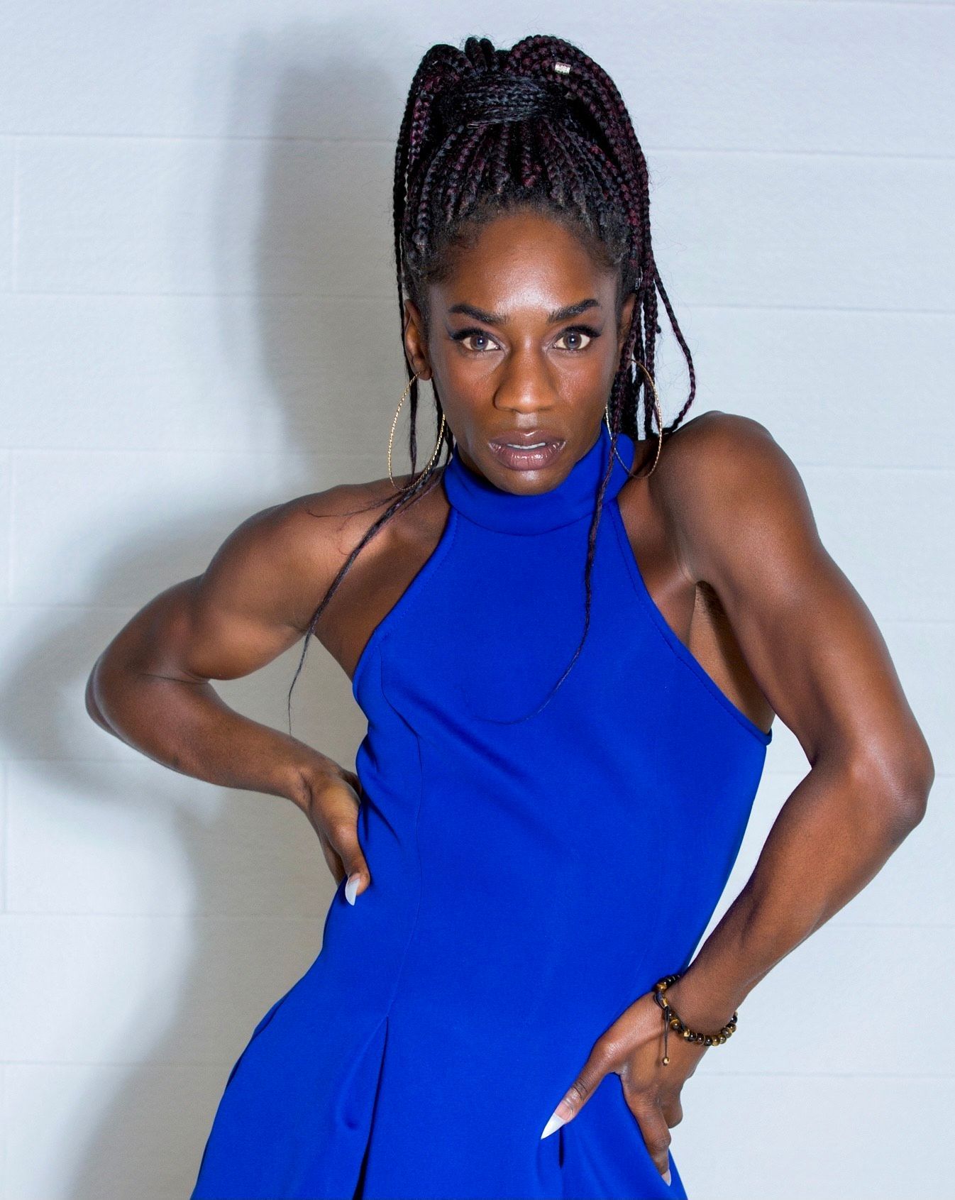 A woman in a blue dress is posing for a picture