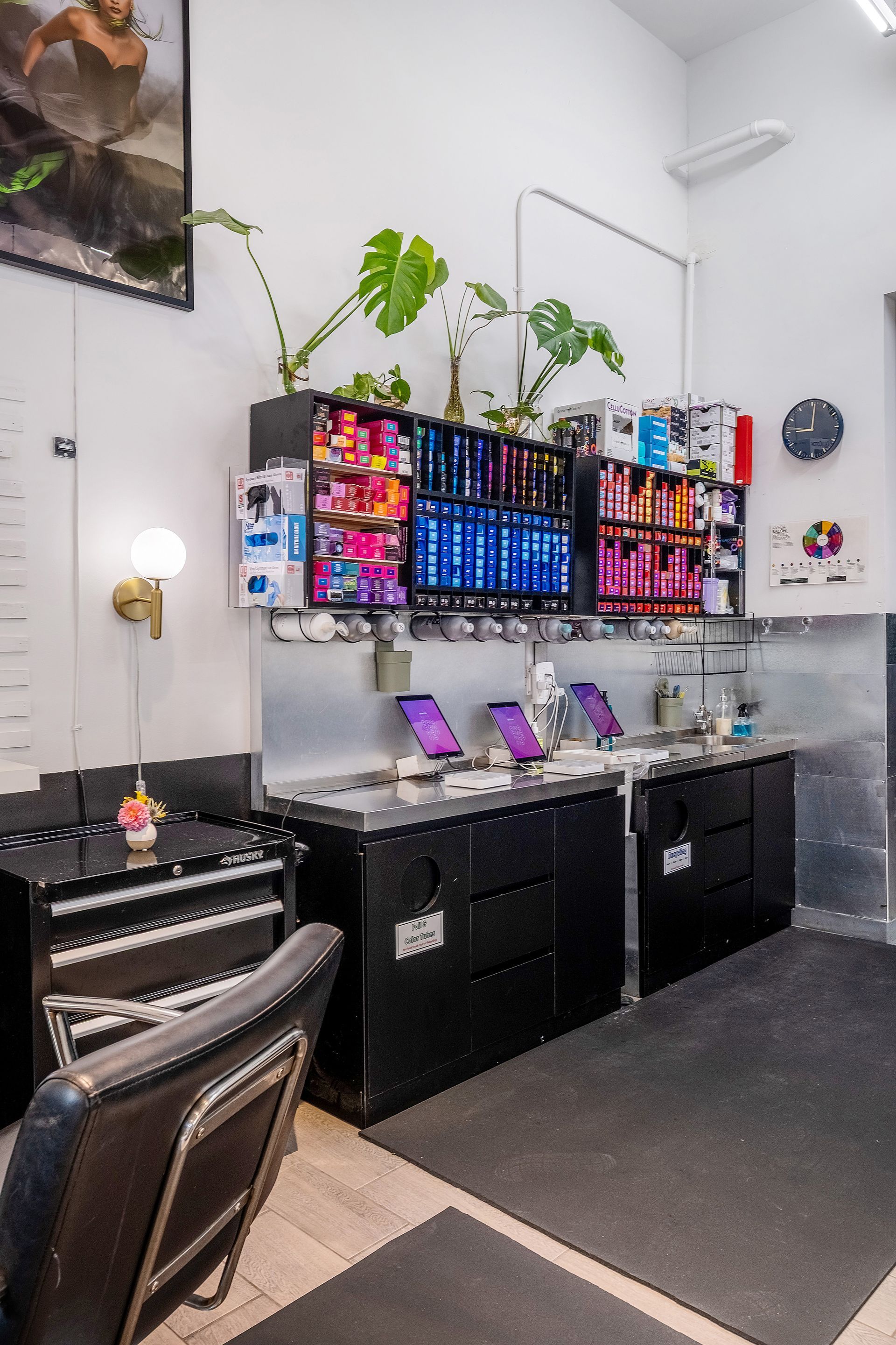 Salon interior with product display, houseplants, and styling stations.