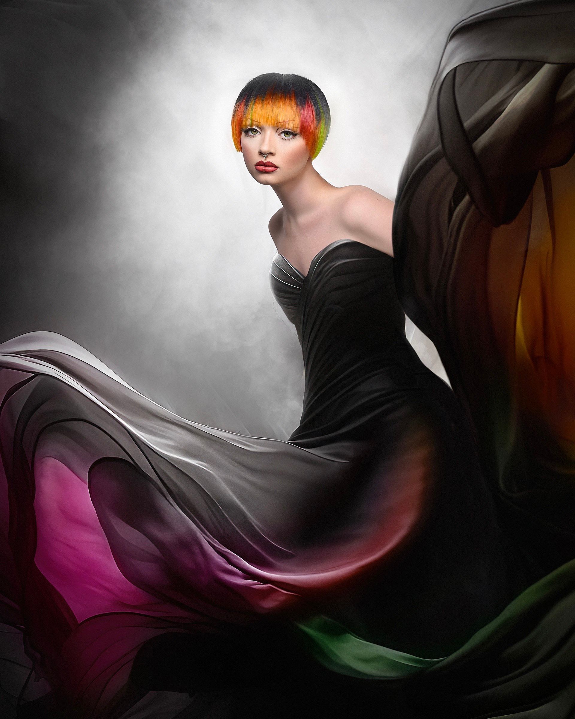 A woman in a black dress with a pink and green skirt