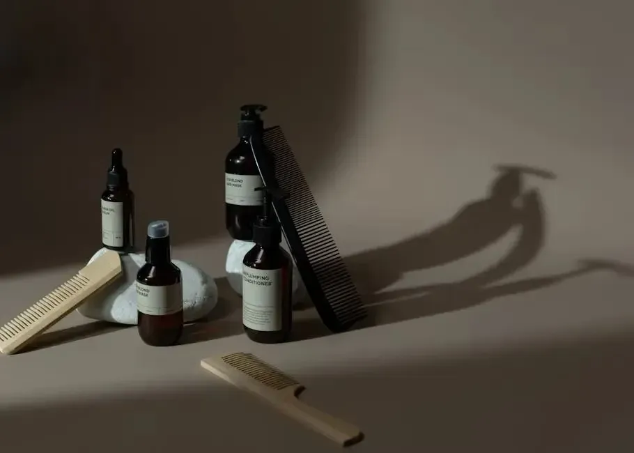A table topped with bottles of hair products and combs.