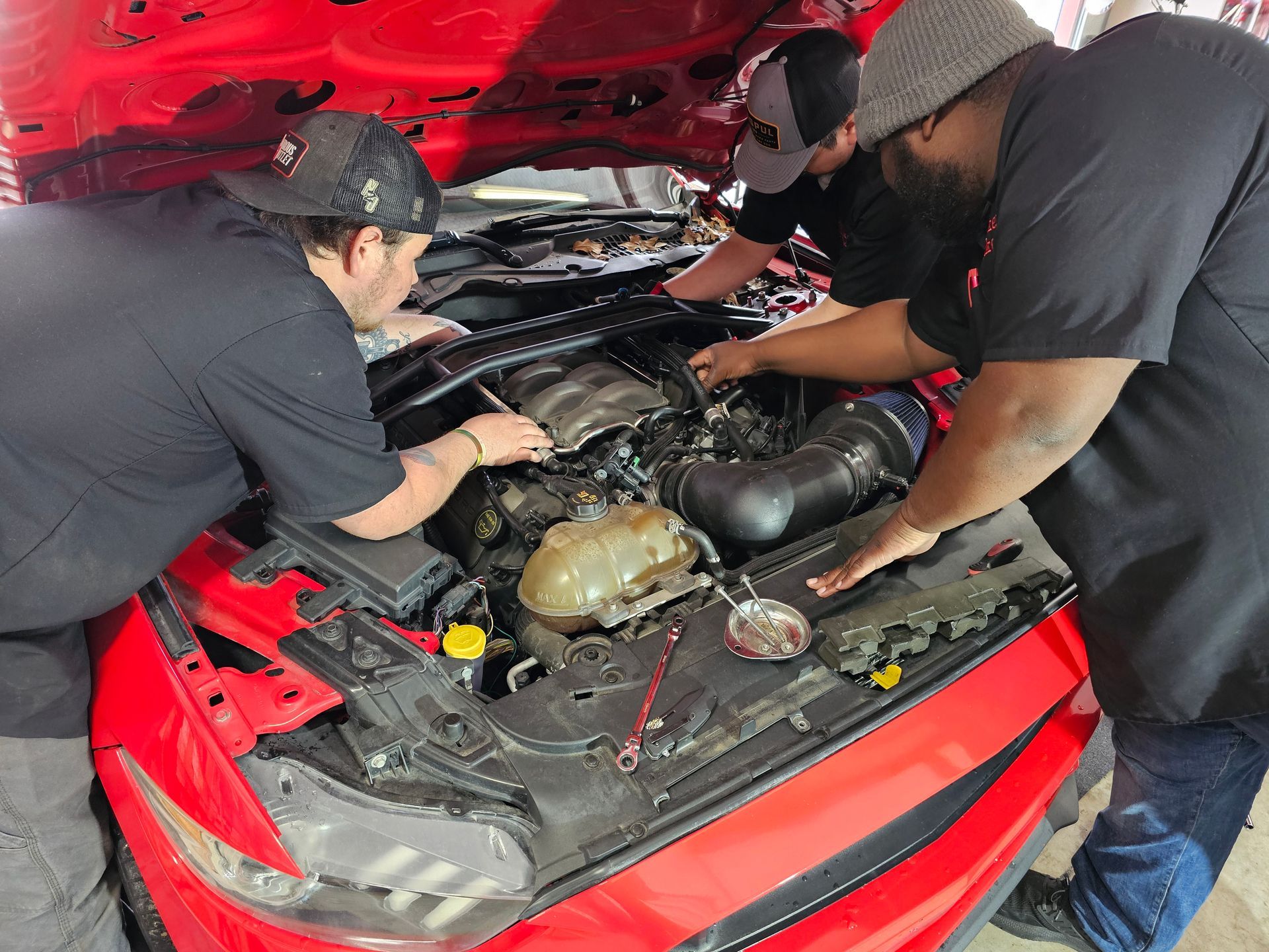 Mechanics performing auto repair services
