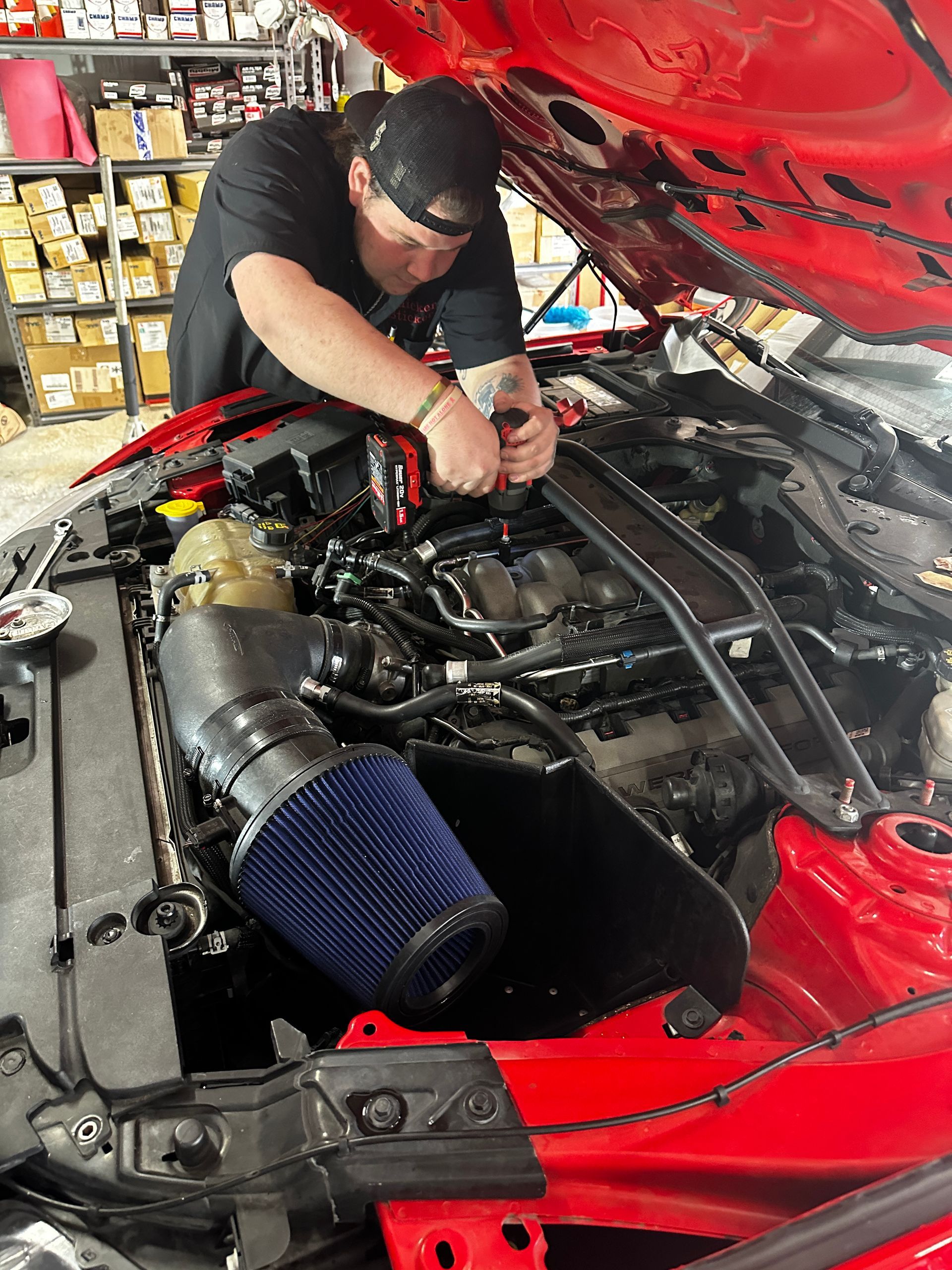 Technician performing repairs on vehicle