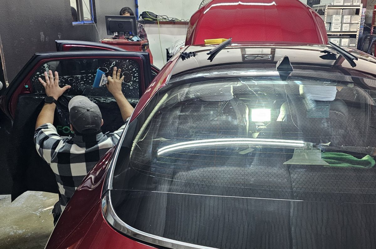 Technician heat curing window tint