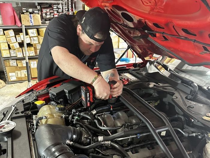 Technician performing digital vehicle inspection during Full Service Oil Change