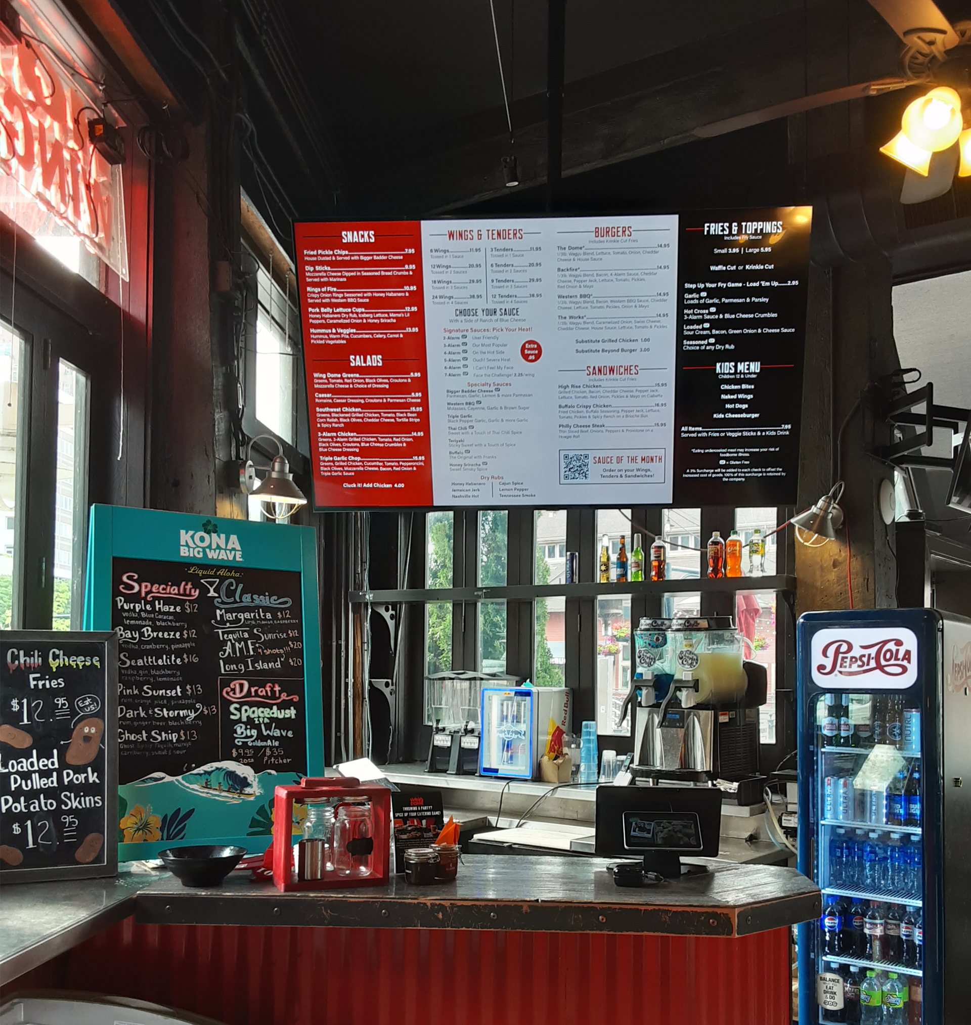 The inside of a restaurant with a pepsi cooler