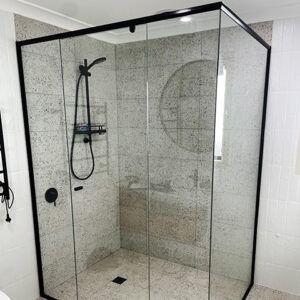 A Bathroom With a Shower Stall With Sliding Glass Doors and a Black Frame — Maryborough Bay Glass & Aluminium in Maryborough, QLD
