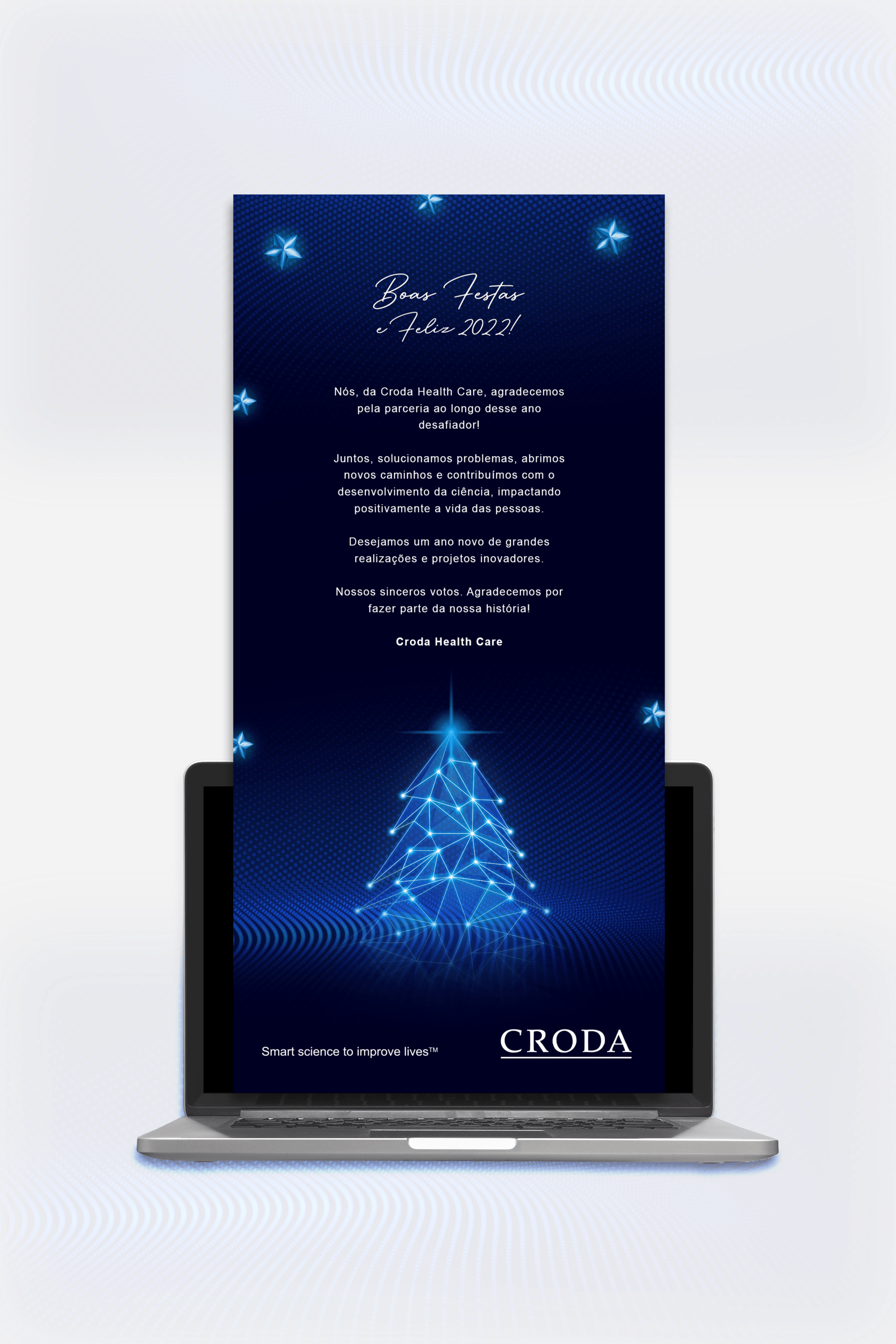 Um laptop com uma árvore de natal na tela.