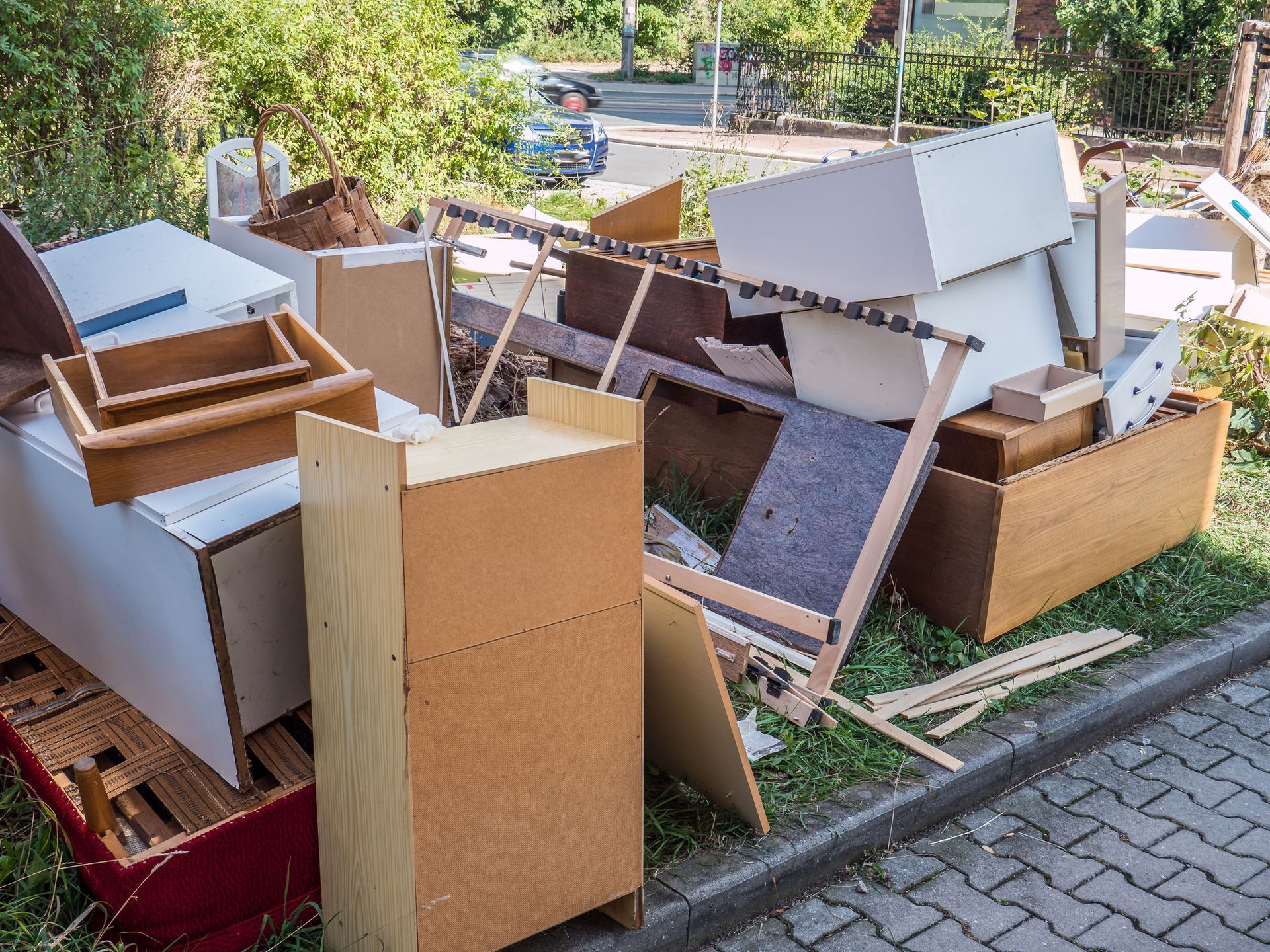 A large collection of junk in front of a house.