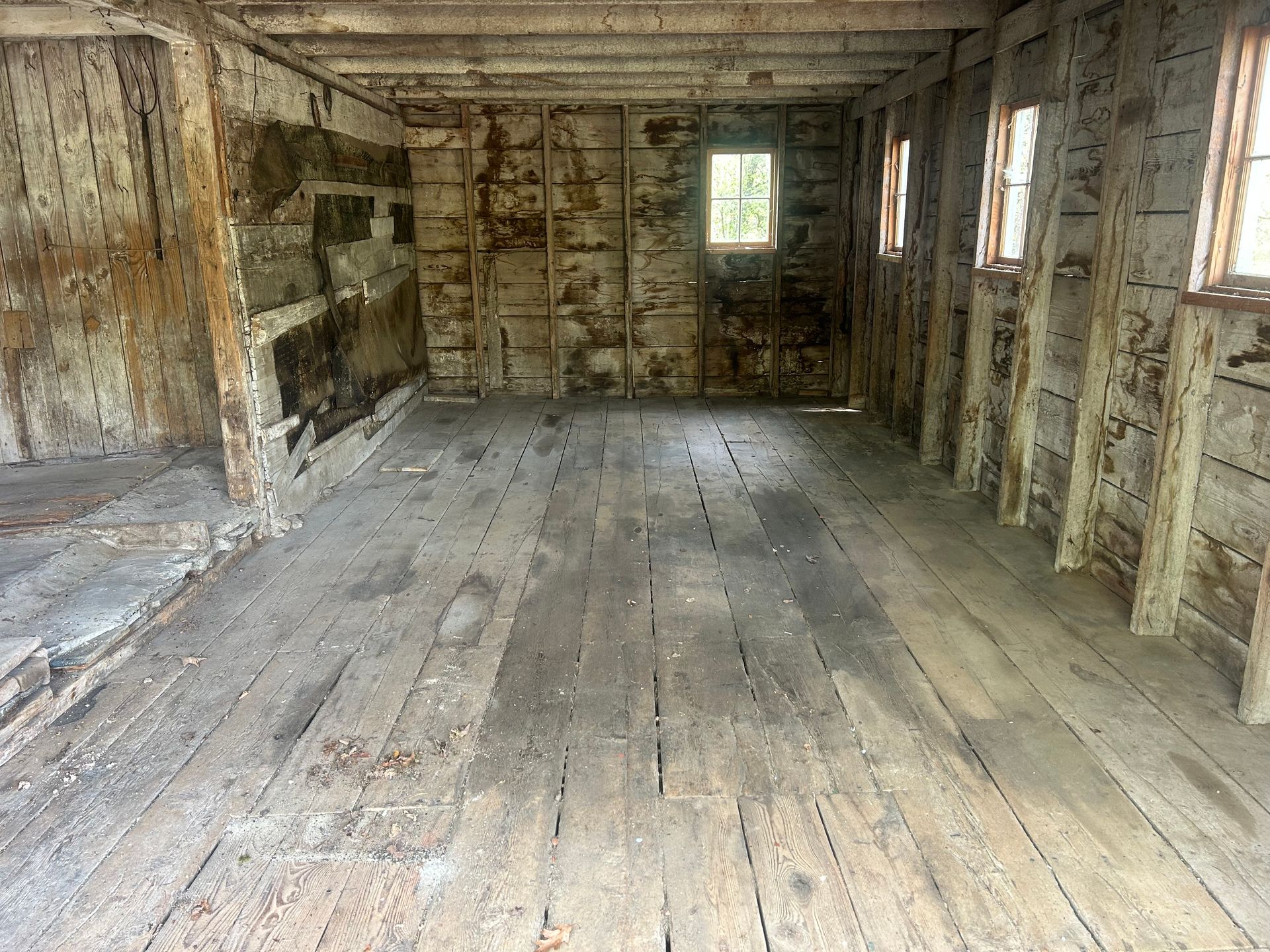 An empty room with wooden floors and walls.