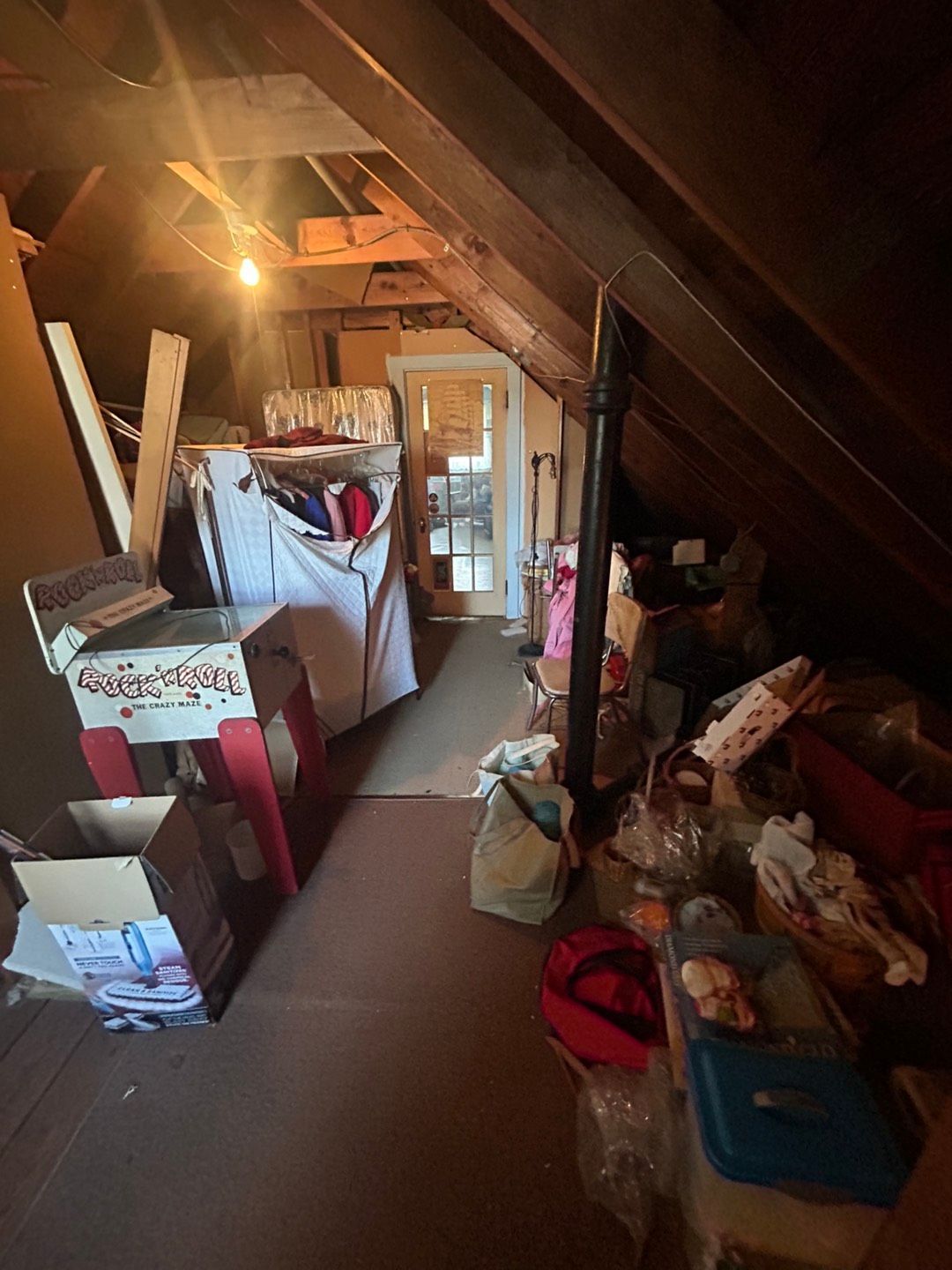 An attic filled with lots of boxes and other items.