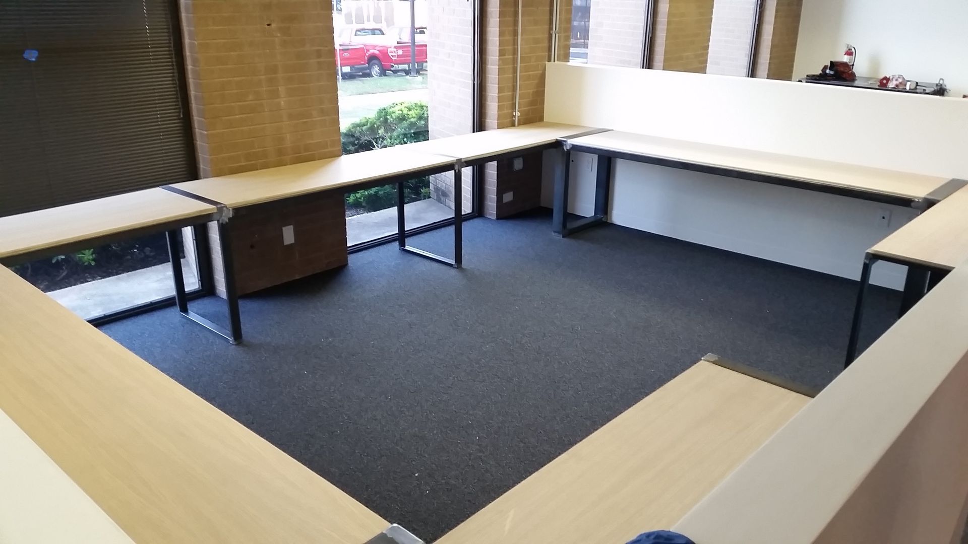 A room with a lot of tables and a window