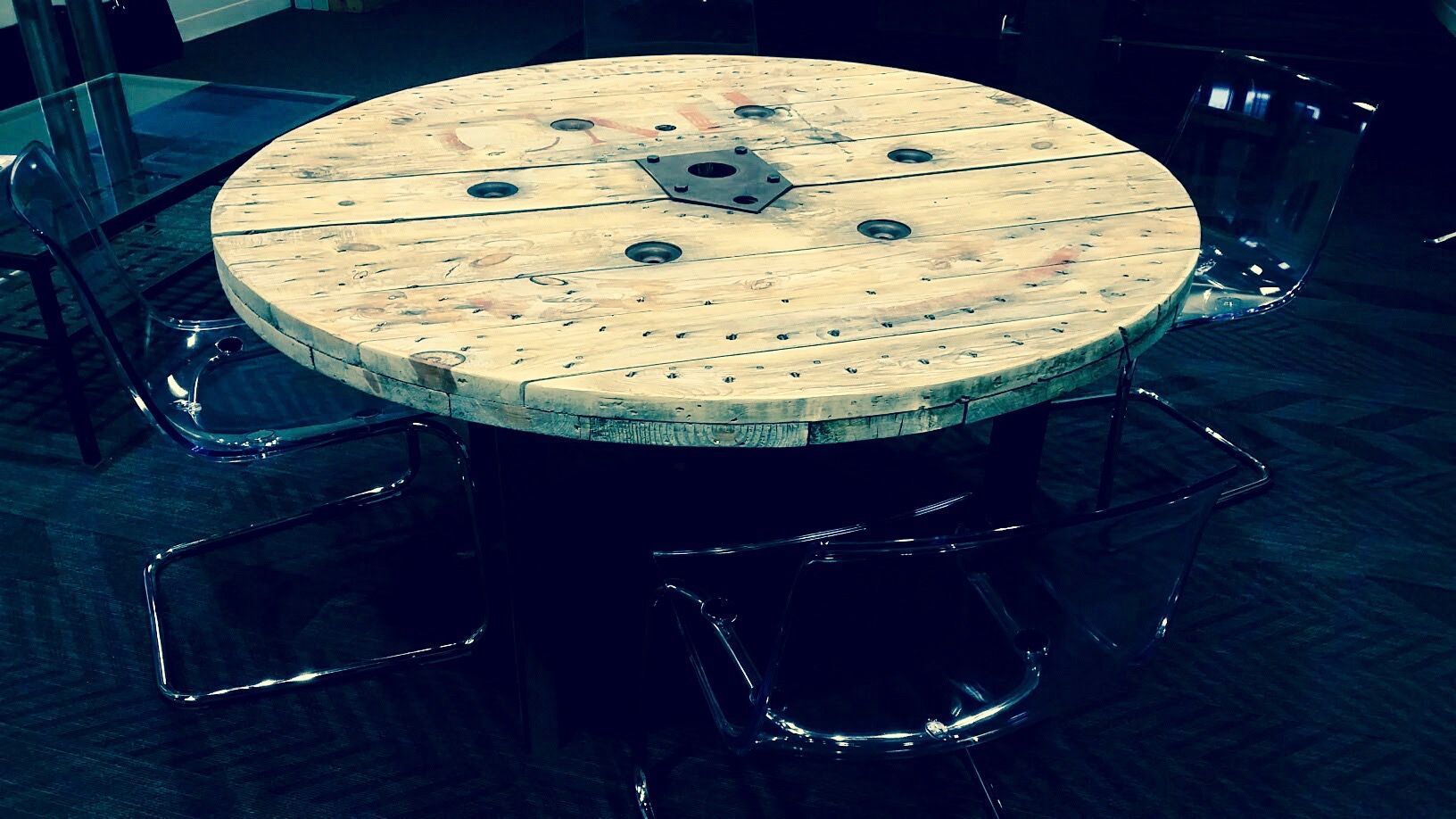 A wooden spool is sitting on top of a table.