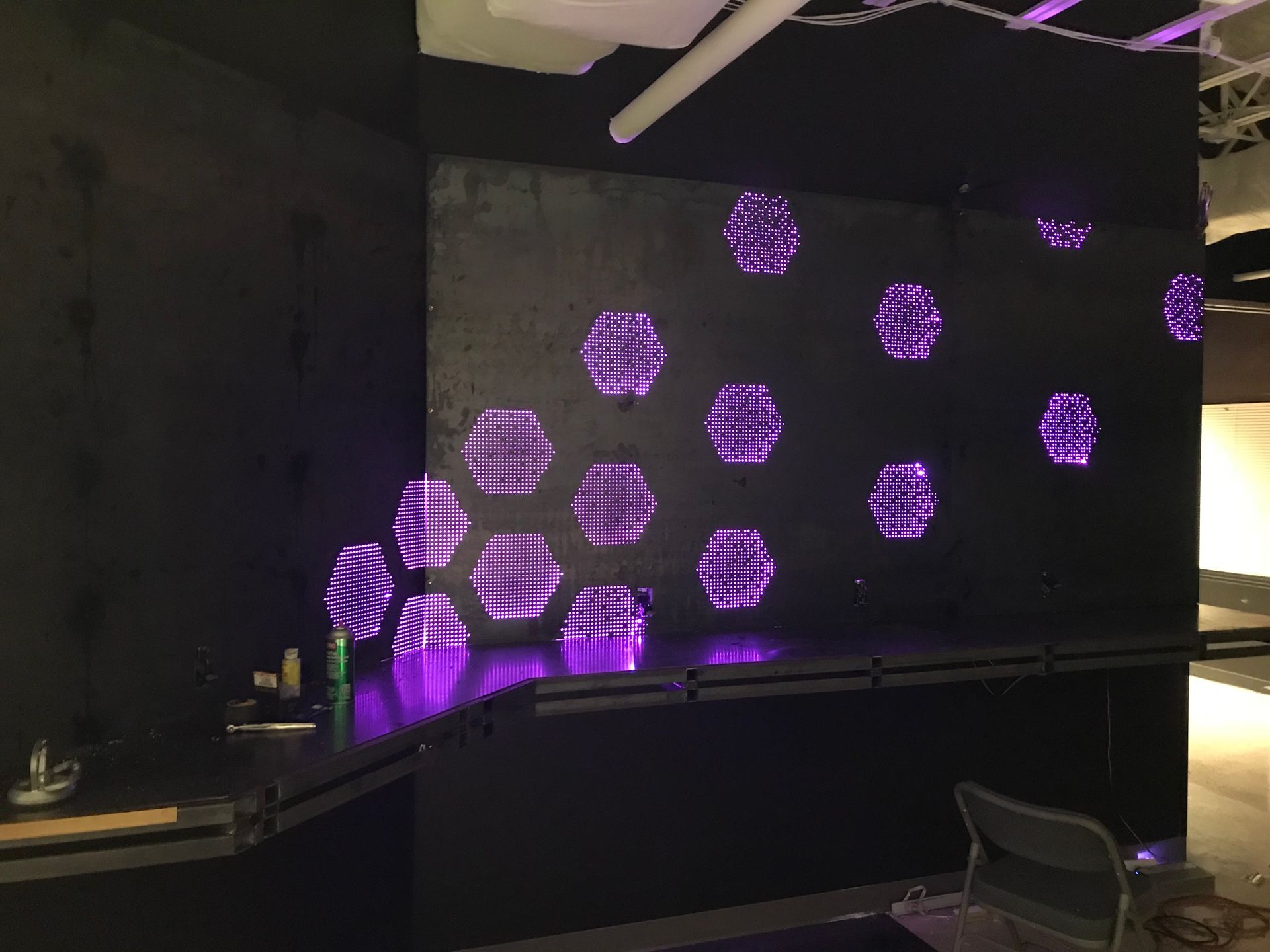 A dark room with purple lights on the wall