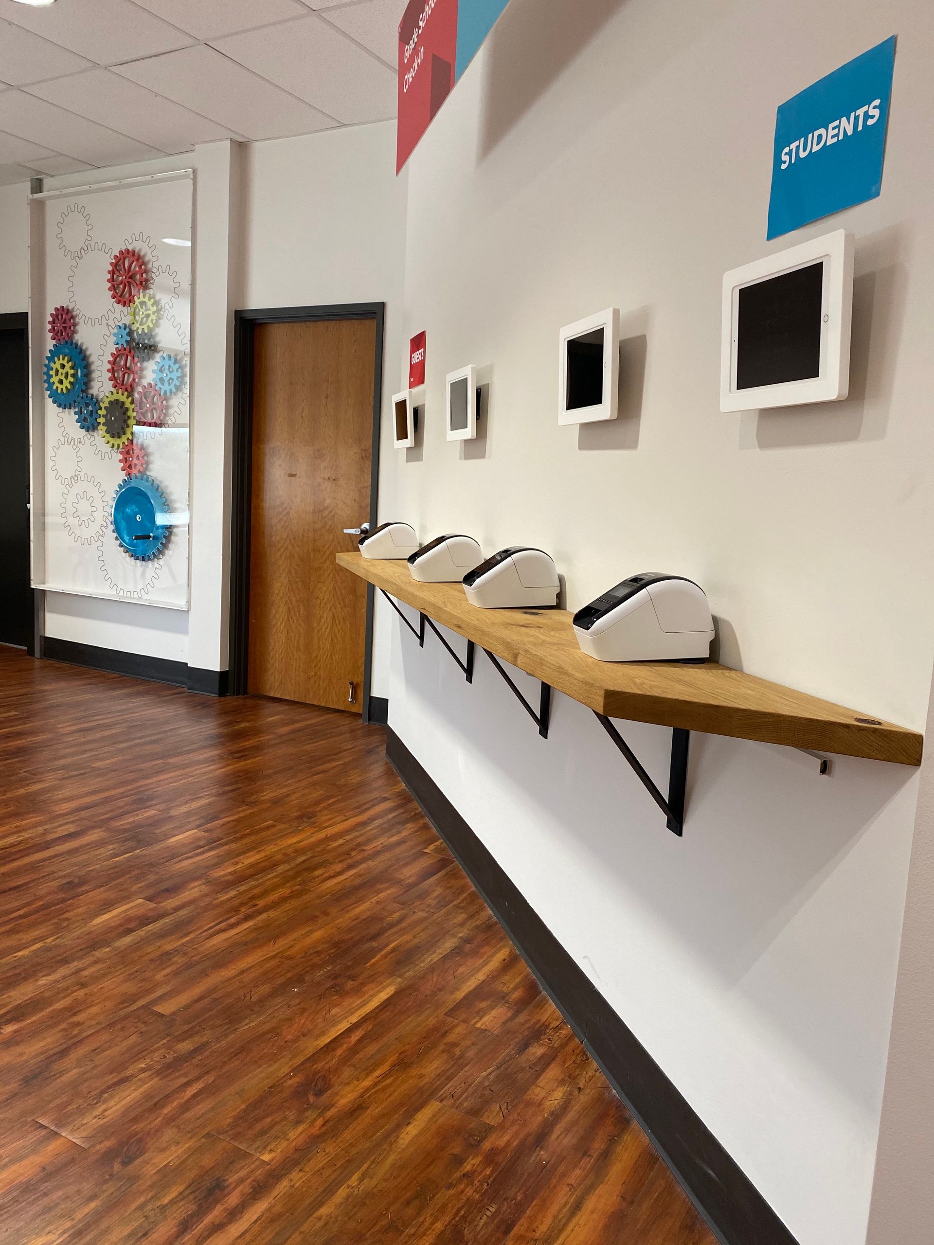 A hallway with a wooden floor and white walls