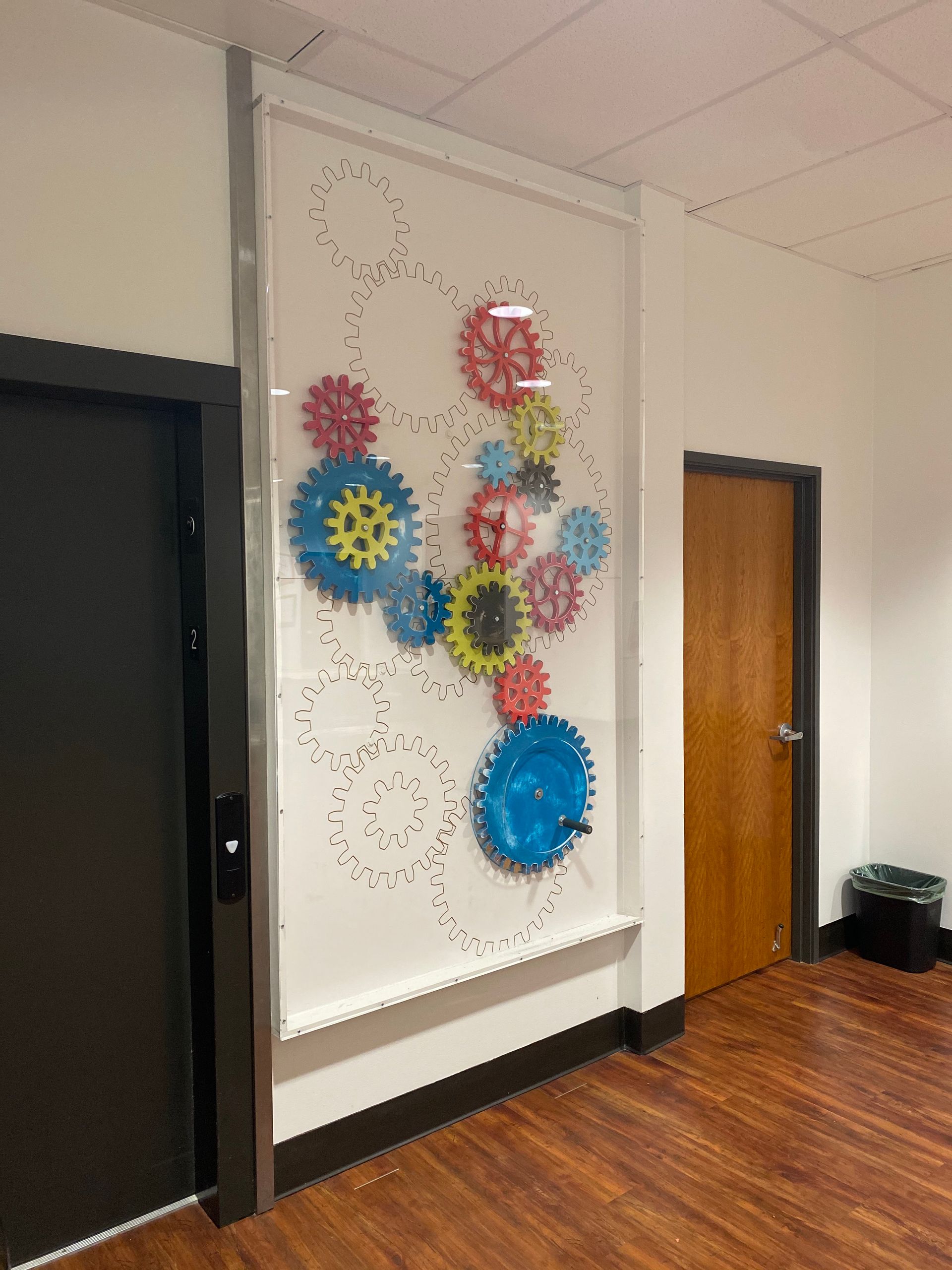 A wall with a bunch of colorful gears on it