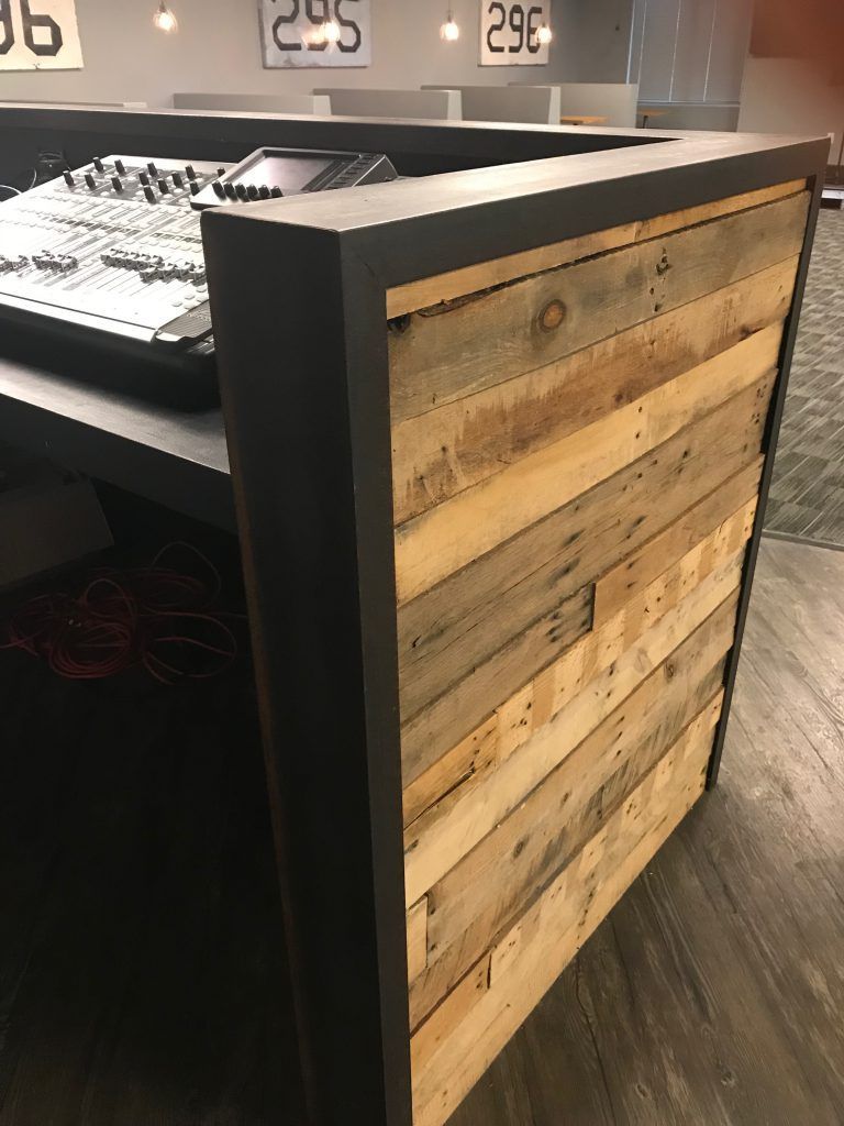 A wooden counter with a mixer on top of it.