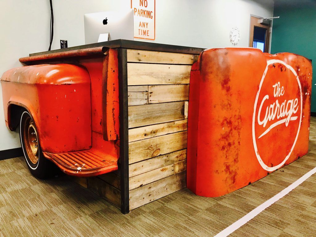 A desk made out of the back of an old truck.