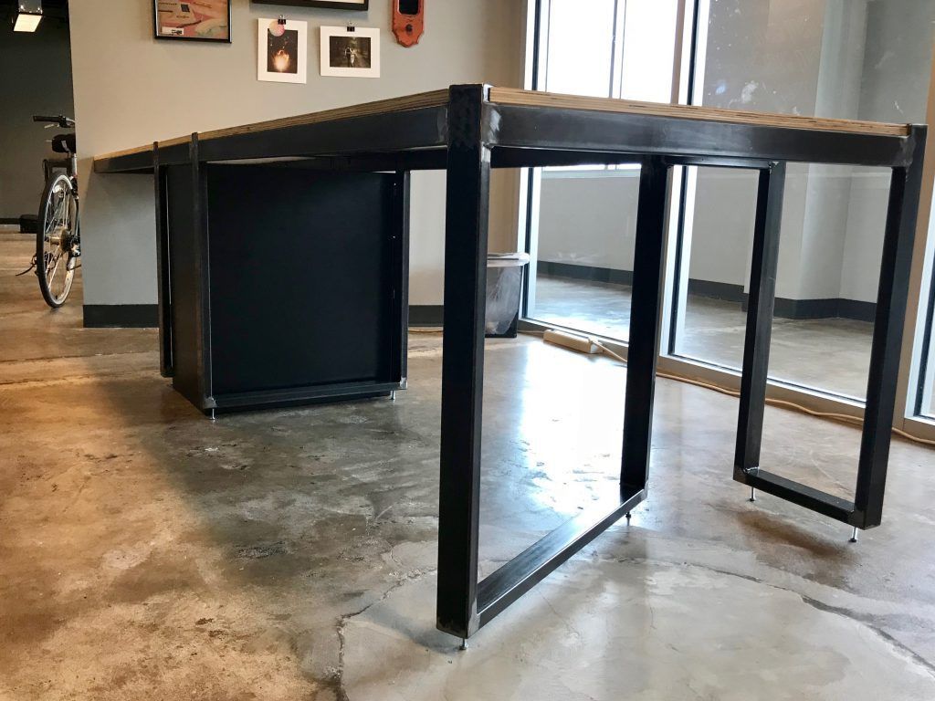 A bicycle is parked next to a table in a room