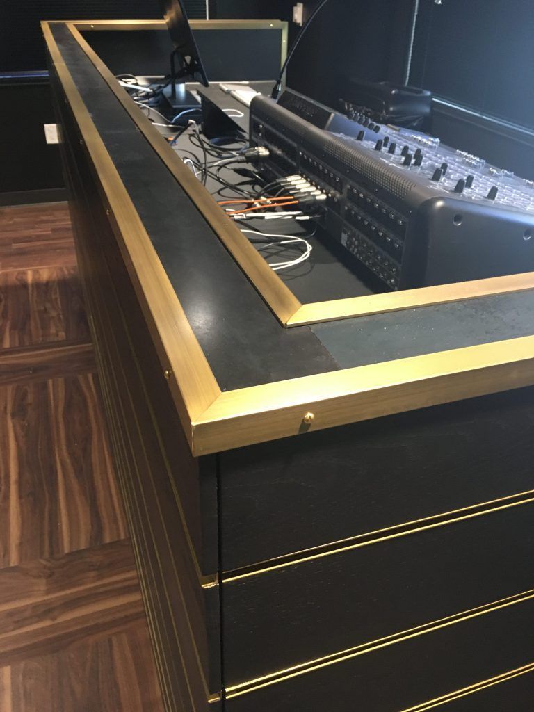 A black counter with gold trim and a computer on it