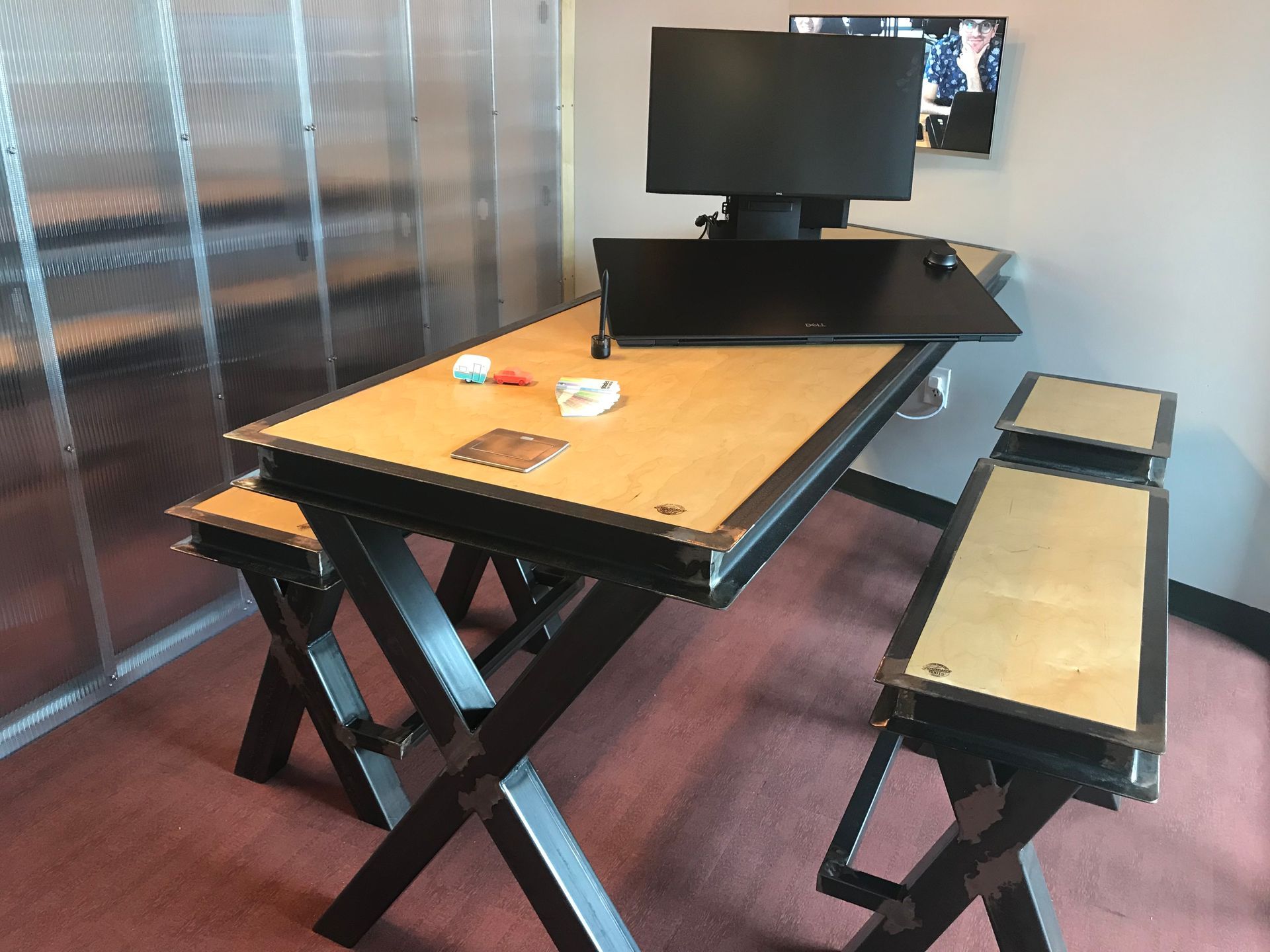 A wooden table with a computer on top of it