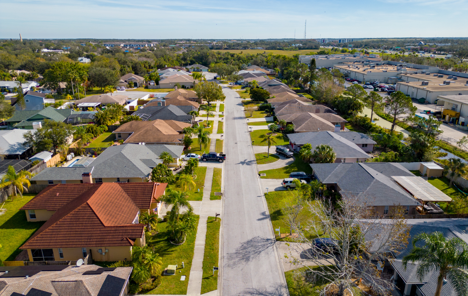 An aerial view of a residential neighborhood with lots of houses and trees.