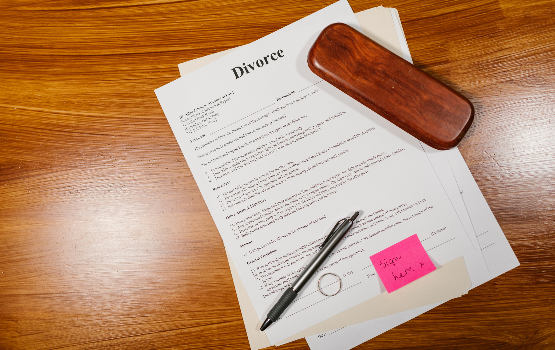A pen is sitting on top of a piece of paper that says divorce.
