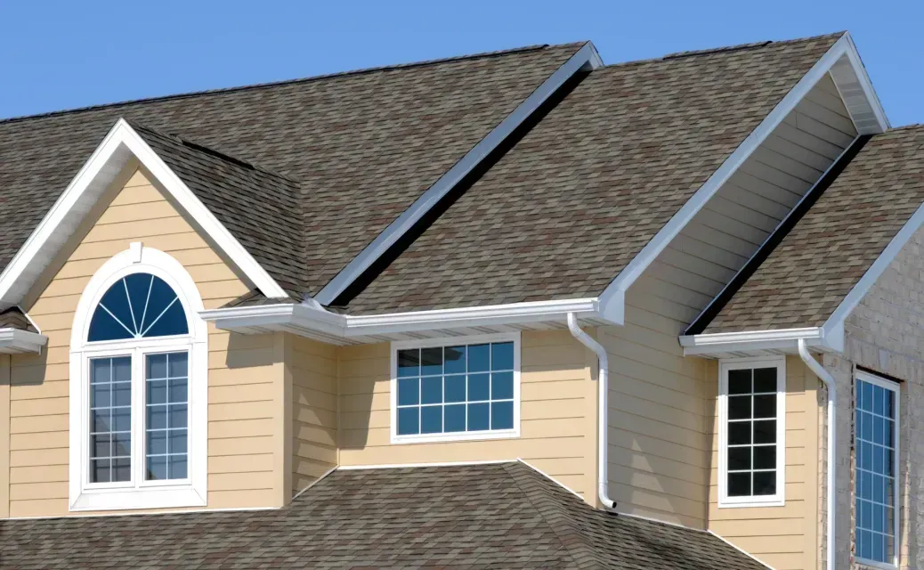 A house with a brown roof and white trim