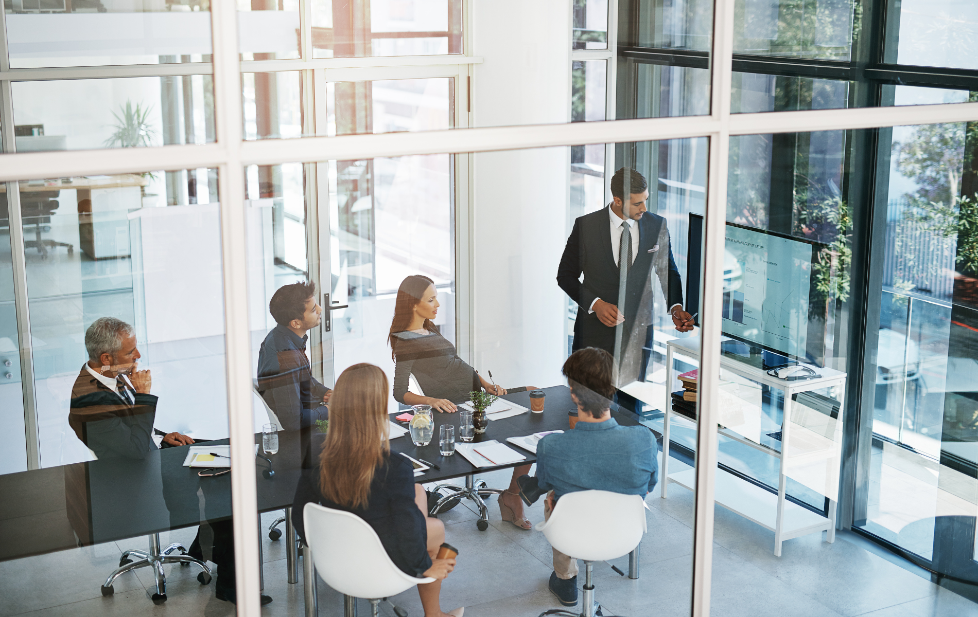 A group of business people are having a meeting in a conference room.