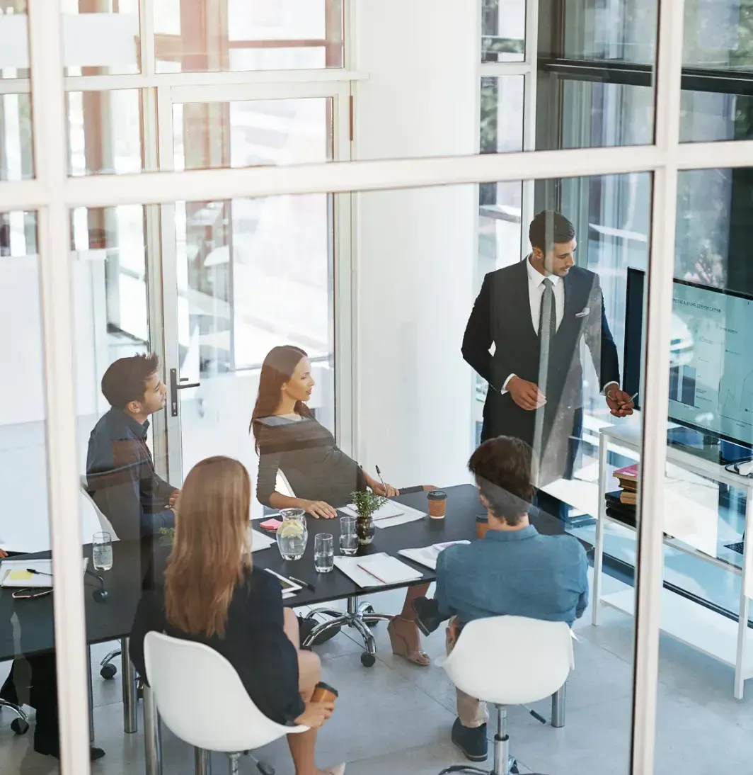 A group of business people are having a meeting in a conference room.