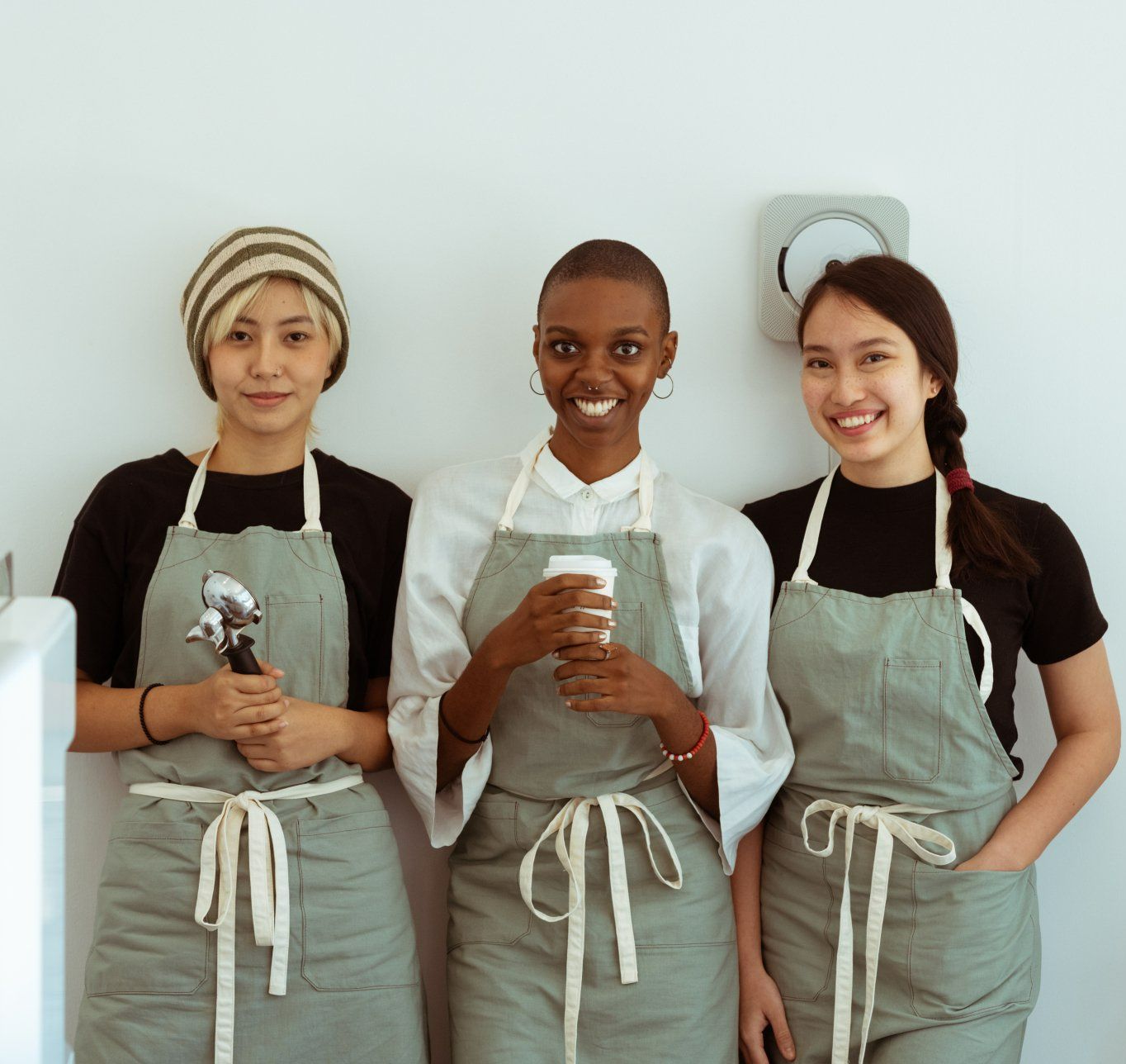 a group of women wearing aprons